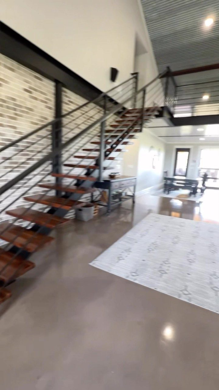 Welded metal and wood staircase in a modern industrial country venue interior