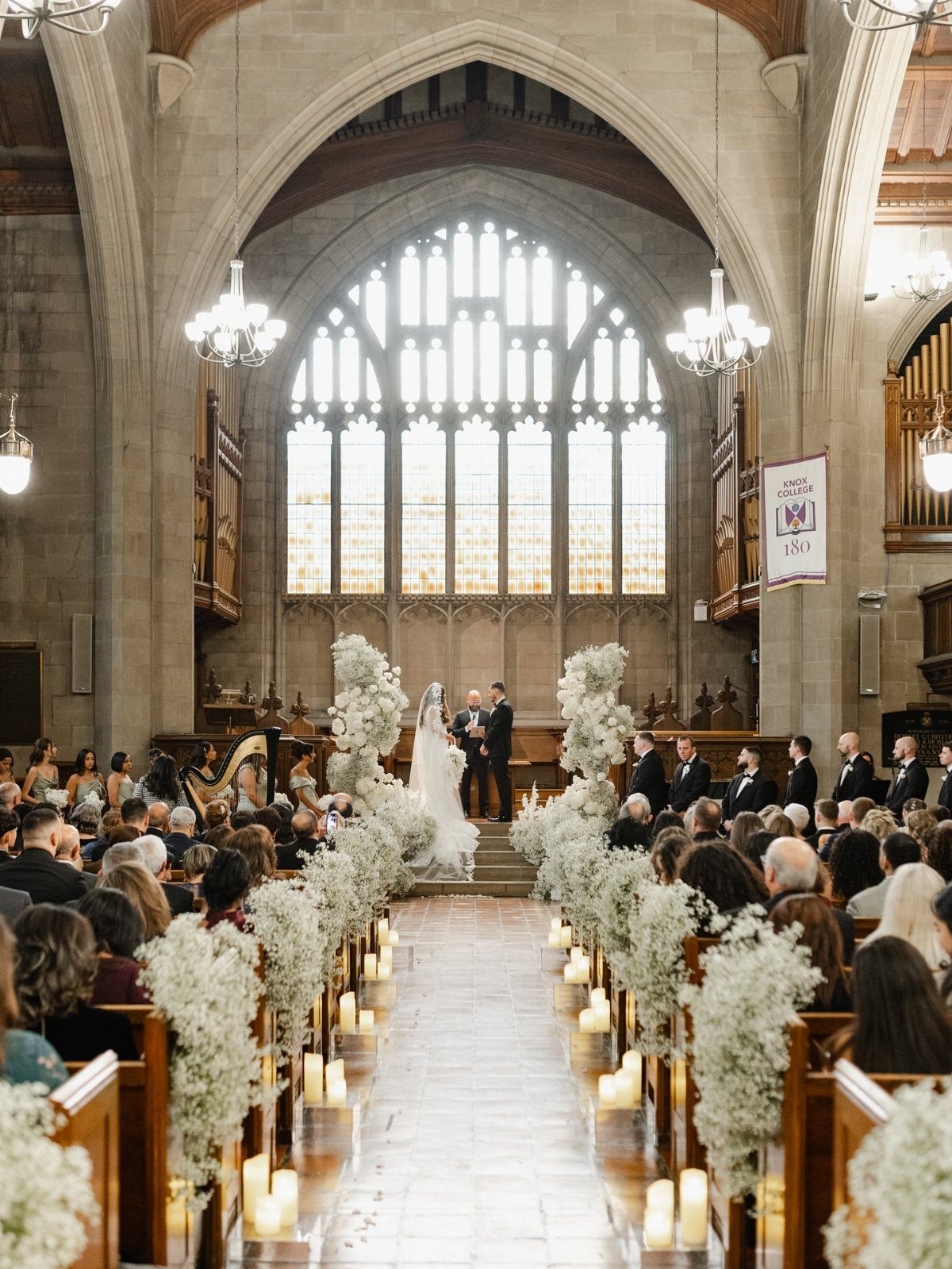 Bride and groom at the altar of a stone church during a wedding ceremony.